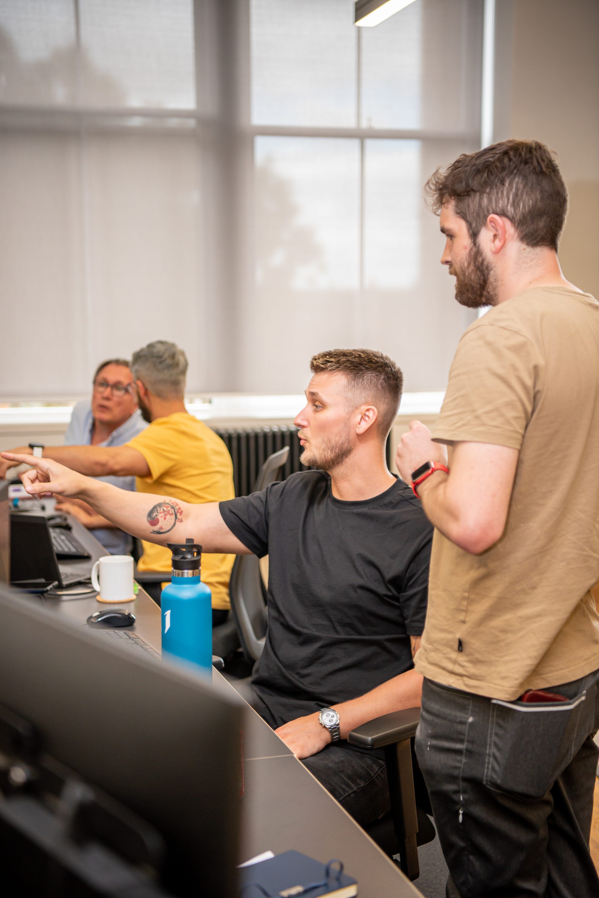 Two male AutoRek employees discussing a project